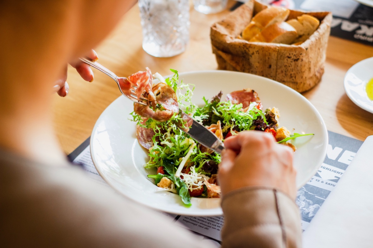 women eating a salad at the restaurant